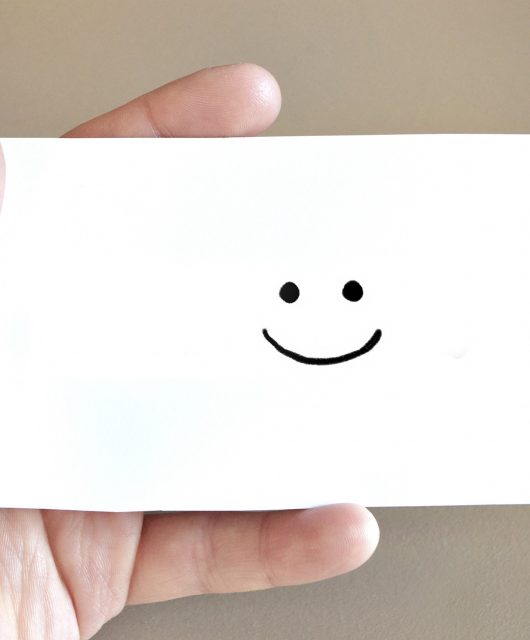 A smiley face on a white card